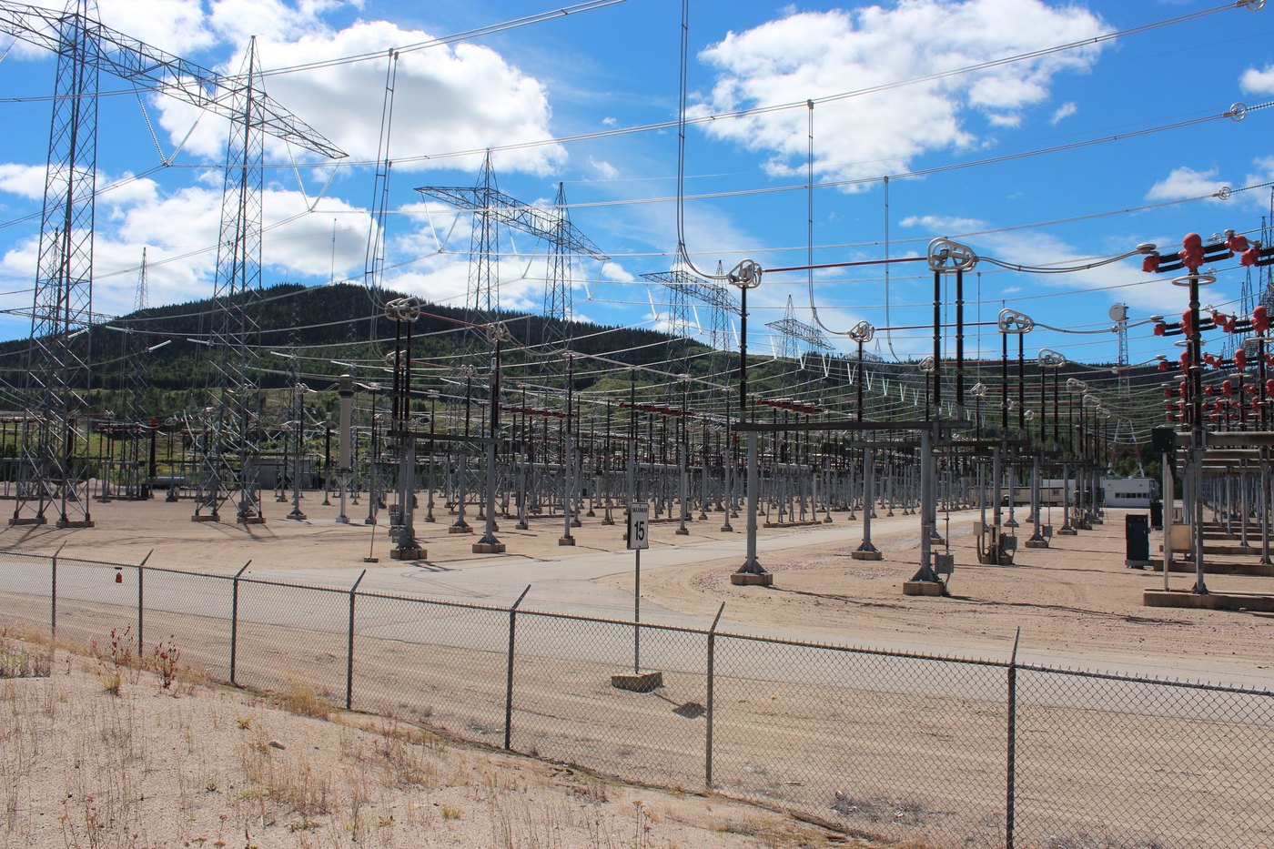 High-voltage switchyard behind a fence